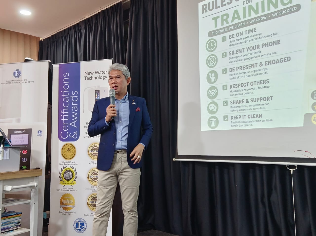 Speaker presenting Enagic training rules at a Kangen Water workshop