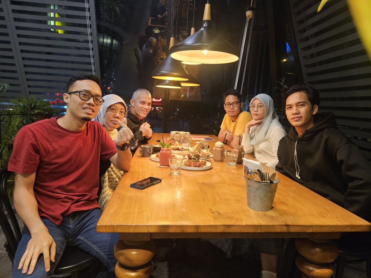 Family enjoying a night out at a city view restaurant