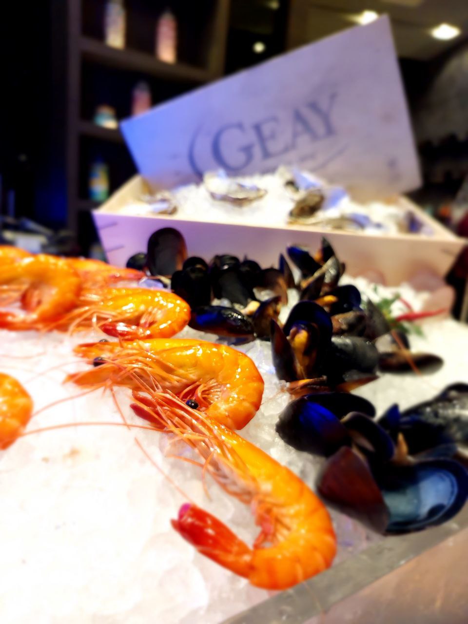 Chilled seafood station with prawns and oysters on ice
